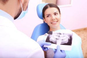 Woman discussing dental xrays with her dentist